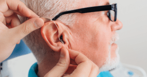 A man getting fitted for hearing aids.